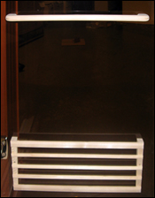 Towel rack and magazine/book holder conveniently located on inside of glass door.